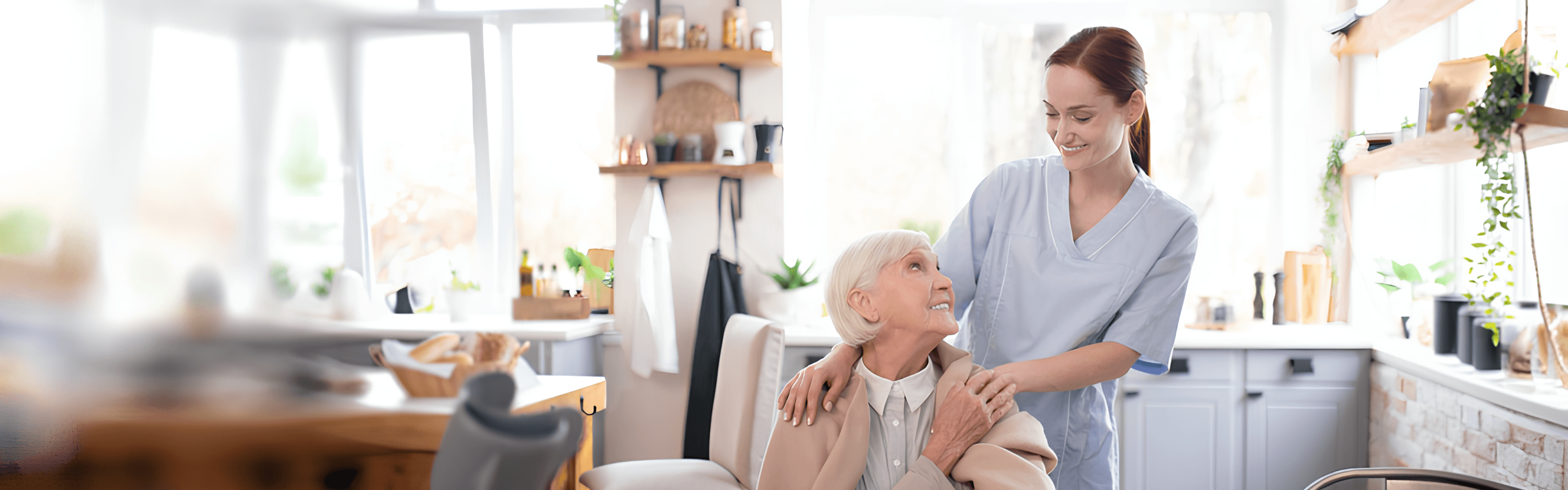 A caregiver supporting a senior in a sunlit living room